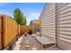 Gravel-covered side yard with wooden fence and access to yard at 8040 E Dartmouth Ave # 16, Denver, CO 80231