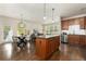 Open concept kitchen with island, stainless steel appliances, and dark wood cabinets at 11213 Colony Cir, Broomfield, CO 80021