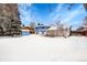 View of backyard with snow, shed, and home's back exterior at 1173 Xenon St, Golden, CO 80401