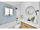 Clean bathroom with light blue tile and modern vanity at 1173 Xenon St, Golden, CO 80401