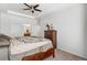 Spacious bedroom boasts a tray ceiling, plush carpet, and access to a private bathroom at 23743 E Ida Pl # E, Aurora, CO 80016