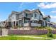 Townhome featuring stone accents, manicured landscaping and inviting curb appeal at 23743 E Ida Pl # E, Aurora, CO 80016
