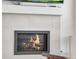 Close-up of a modern gas fireplace with white tile surround and a floating mantel at 23743 E Ida Pl # E, Aurora, CO 80016