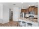 Bright kitchen featuring a granite island, stainless steel appliances, and nearby laundry at 23743 E Ida Pl # E, Aurora, CO 80016