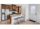 Charming kitchen with granite island, stainless appliances, and cozy bar stool seating at 23743 E Ida Pl # E, Aurora, CO 80016