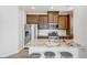 Modern kitchen features a granite island with seating, stainless steel appliances, and white backsplash at 23743 E Ida Pl # E, Aurora, CO 80016