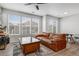 A well lit living room boasts a leather sofa, entertainment area, and large windows at 23743 E Ida Pl # E, Aurora, CO 80016