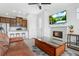 Open-concept living space with a kitchen, dining area, living room, and modern fireplace at 23743 E Ida Pl # E, Aurora, CO 80016
