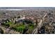 Wide aerial view of a neighborhood with mature trees and a large building with a terracotta roof at 3233 Meade St, Denver, CO 80211