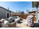 Backyard features outdoor seating, a covered grill, and a fenced perimeter at 3233 Meade St, Denver, CO 80211