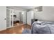Finished basement rec room with polished wood floor, beanbag chair, and sliding barn doors to a bedroom at 3233 Meade St, Denver, CO 80211