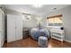 Finished basement rec room featuring a comfortable beanbag chair, mini-fridge, and wood-look flooring at 3233 Meade St, Denver, CO 80211