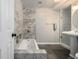 Beautiful bathroom with gray tile accent wall, soaking tub, and stylish pedestal sink at 3233 Meade St, Denver, CO 80211