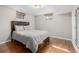Cozy bedroom featuring laminate flooring, neutral decor, and natural light from two windows at 3233 Meade St, Denver, CO 80211