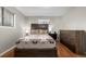 Cozy bedroom with a southwestern-style blanket, wood flooring, dresser and bright windows at 3233 Meade St, Denver, CO 80211