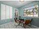 Bright dining area with a window showcasing plant decor and a modern glass table at 3233 Meade St, Denver, CO 80211