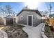 A garage in a backyard with siding and a large door at 3233 Meade St, Denver, CO 80211
