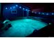 Inviting hot tub with illuminated jets and backyard lighting at 3233 Meade St, Denver, CO 80211