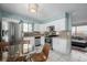 Modern kitchen with stainless steel appliances, white cabinetry, and adjacent dining area at 3233 Meade St, Denver, CO 80211