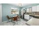 Well-lit kitchen with stainless steel appliances, granite countertops, and a cozy dining area at 3233 Meade St, Denver, CO 80211