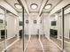 Bathroom hallway with mirrored closet doors and vanity sinks on either side at 15911 E Dakota Pl # 301, Aurora, CO 80017