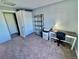 Cozy bedroom features a desk and shelving, making it ideal for a home office at 15911 E Dakota Pl # 301, Aurora, CO 80017