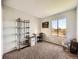 Bedroom featuring a large window with neighborhood views and a wall with a built in shelving system at 15911 E Dakota Pl # 301, Aurora, CO 80017