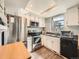 Bright kitchen features white cabinets, stainless steel appliances, and granite countertops at 15911 E Dakota Pl # 301, Aurora, CO 80017