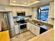 Bright kitchen boasts stainless steel appliances, granite countertops, and ample cabinet space at 15911 E Dakota Pl # 301, Aurora, CO 80017