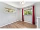 Bedroom featuring natural light, wood floors, and red curtains at 6538 S Lee Ct, Centennial, CO 80121