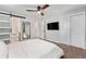 Bedroom with hardwood floors, sliding barn door, modern ceiling fan, and closet with sliding doors at 6538 S Lee Ct, Centennial, CO 80121