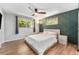 Bedroom boasts an accent wall, natural light from two windows, and ceiling fan at 6538 S Lee Ct, Centennial, CO 80121