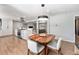 Open concept dining room with modern pendant lighting, hardwood floors and adjacent living room at 6538 S Lee Ct, Centennial, CO 80121