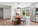 Cozy dining area with a unique wood table, stylish chairs, and French doors at 6538 S Lee Ct, Centennial, CO 80121
