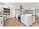 Modern kitchen with stainless gas range, quartz counters, custom cabinets and hardwood floors at 6538 S Lee Ct, Centennial, CO 80121