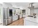 Stylish kitchen with stainless steel appliances, white cabinets, and quartz countertops at 6538 S Lee Ct, Centennial, CO 80121