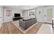 Bright living room with hardwood floors, modern furniture, and a large bay window at 6538 S Lee Ct, Centennial, CO 80121
