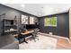 Office with natural light, built-in shelving, wood floors, and a modern adjustable desk at 6538 S Lee Ct, Centennial, CO 80121