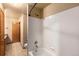 Clean bathroom featuring a shower over tub with white tiles and a light-colored vanity at 21444 E Lehigh Ave, Aurora, CO 80013