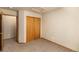 Standard bedroom with neutral walls, carpet, a closet with wood sliding doors, and a window at 21444 E Lehigh Ave, Aurora, CO 80013