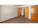 Cozy bedroom with neutral-colored walls, carpet flooring, and a standard closet with sliding doors at 21444 E Lehigh Ave, Aurora, CO 80013