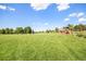 Expansive green open field with a community playground and blue skies in the background at 21444 E Lehigh Ave, Aurora, CO 80013