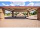 Outdoor brick community pavilion featuring a red roof, picnic tables and a fireplace on a brick surface at 21444 E Lehigh Ave, Aurora, CO 80013