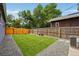 A fully fenced backyard featuring artificial turf and decorative rock at 3346 W 33Rd Ave, Denver, CO 80211