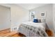 Comfortable bedroom featuring hardwood floors, a window, and calming neutral decor at 3346 W 33Rd Ave, Denver, CO 80211