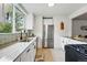 Modern kitchen with white cabinets, stainless steel appliances, gorgeous counters, and a mosaic tile backsplash at 3346 W 33Rd Ave, Denver, CO 80211