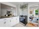 Stylish kitchen featuring white cabinetry, stainless steel appliances, and a view to the living area at 3346 W 33Rd Ave, Denver, CO 80211