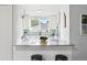 Bright kitchen with white cabinets, stainless steel appliances, a view of the backyard, and marble countertop at 3346 W 33Rd Ave, Denver, CO 80211