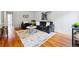 Open concept living room with hardwood floors, gray couches, white walls, and modern decor at 3346 W 33Rd Ave, Denver, CO 80211