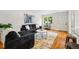 Inviting living room featuring a large window, hardwood floors, and stylish decor at 3346 W 33Rd Ave, Denver, CO 80211